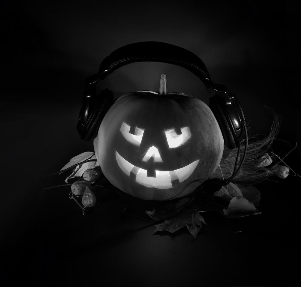 scary pumpkin DJ on a dark background